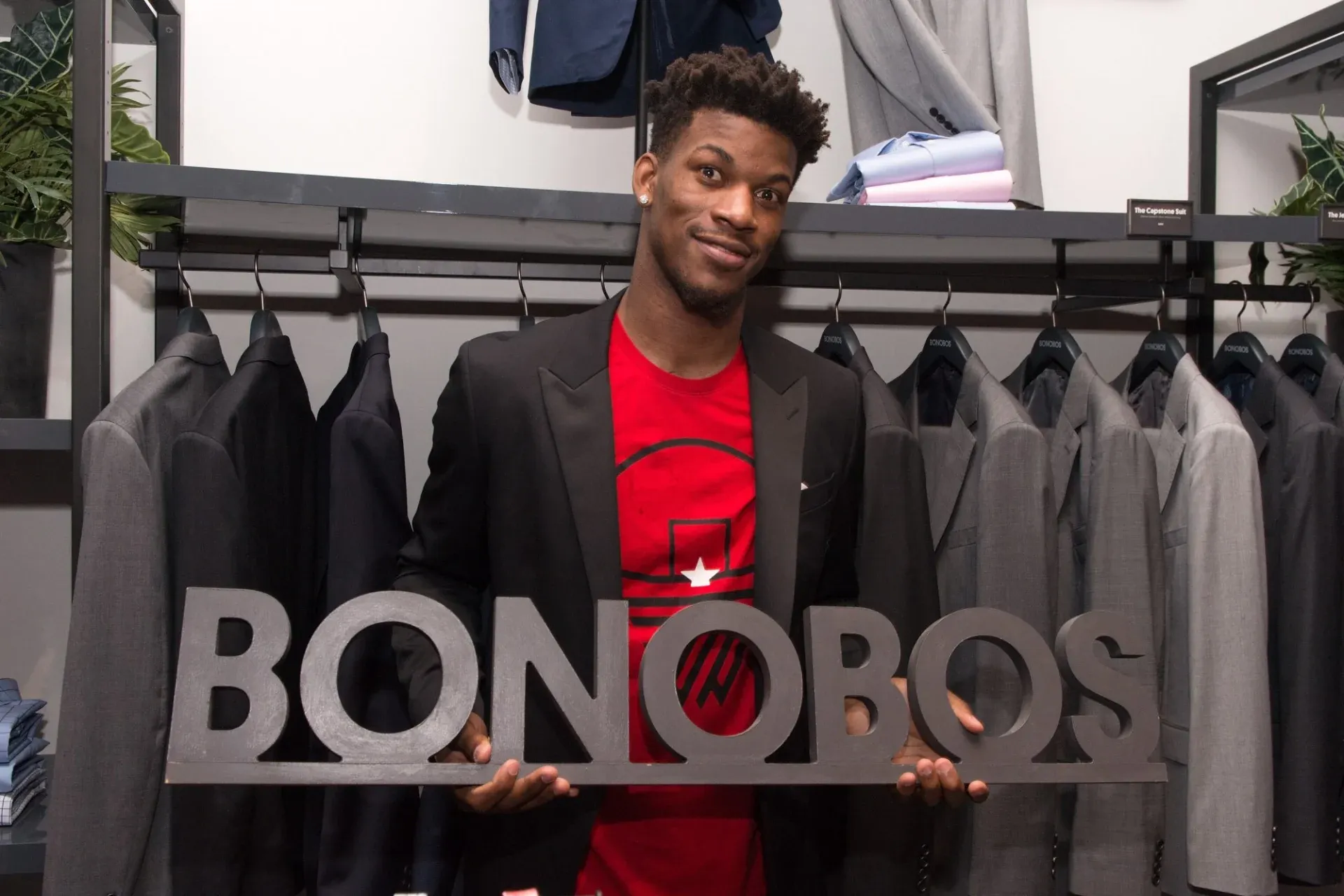 The CEO of bonobos holding their sign