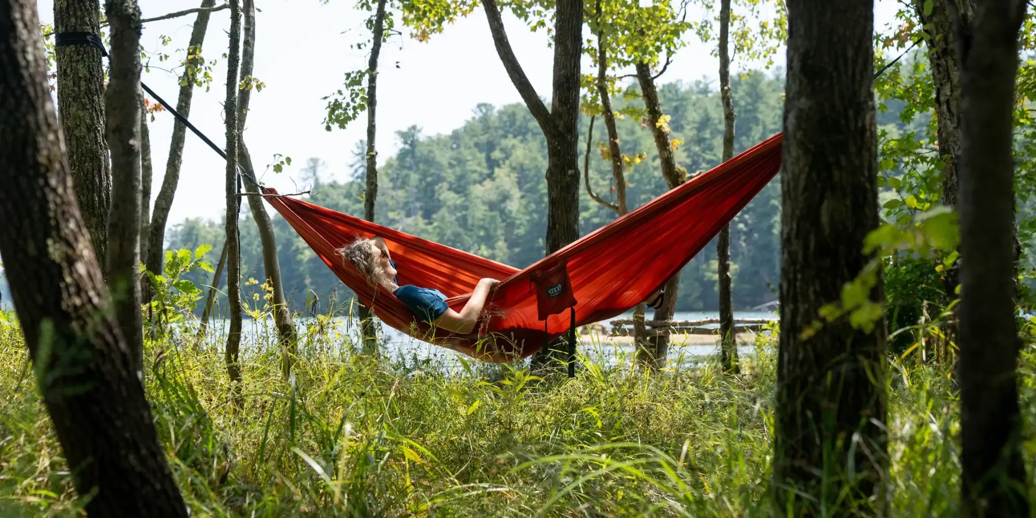 Relaxing in a red hammock among the trees Relaxing in a red hammock among the trees